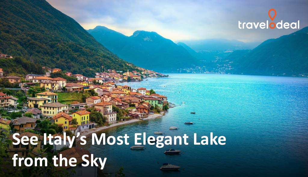 Aerial view of Italy's elegant lake surrounded by charming villages and mountains, showcasing vibrant colors and serene waters.